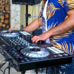 DJ Hands creating and regulating music on dj console mixer in concert party outdoor openair