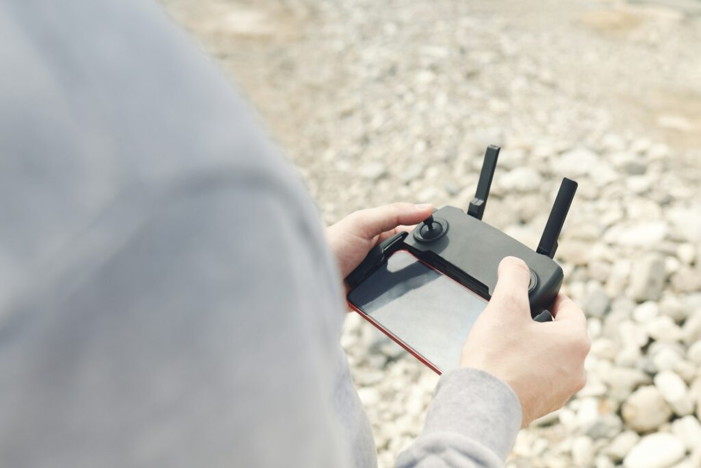 Male hands holding dron remote controller doing some setings